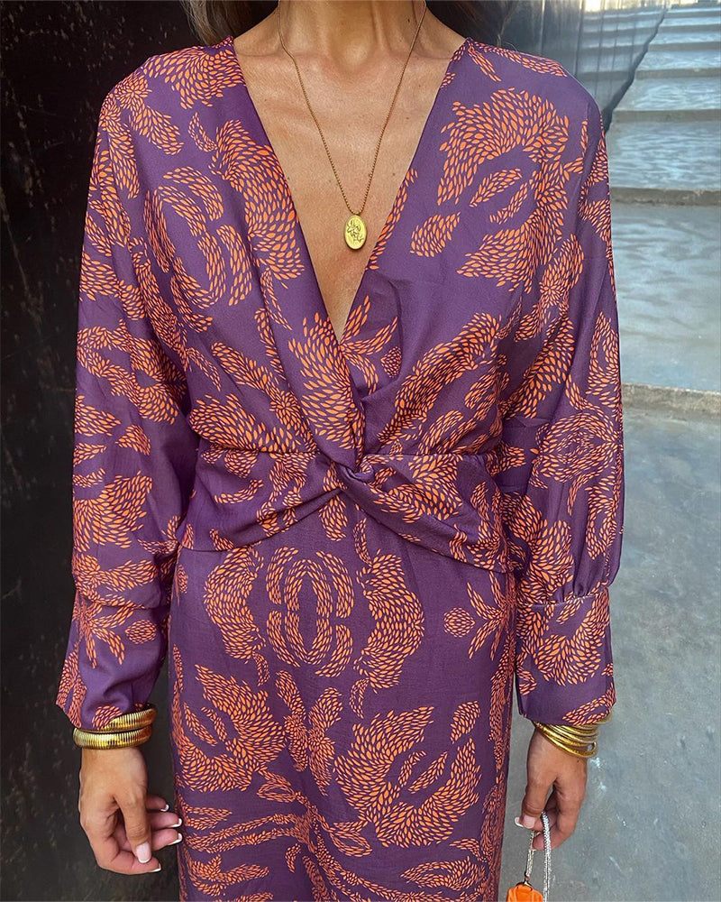 A woman wearing a floral maxi dress with an elegant fit, styled with statement accessories and heels, perfect for formal events or casual outings.