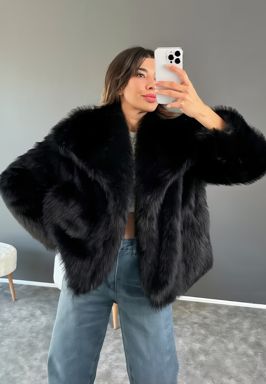 A stylish woman wearing a luxurious faux fur coat, paired with casual jeans, capturing a chic winter look perfect for elegant outings or casual wear.