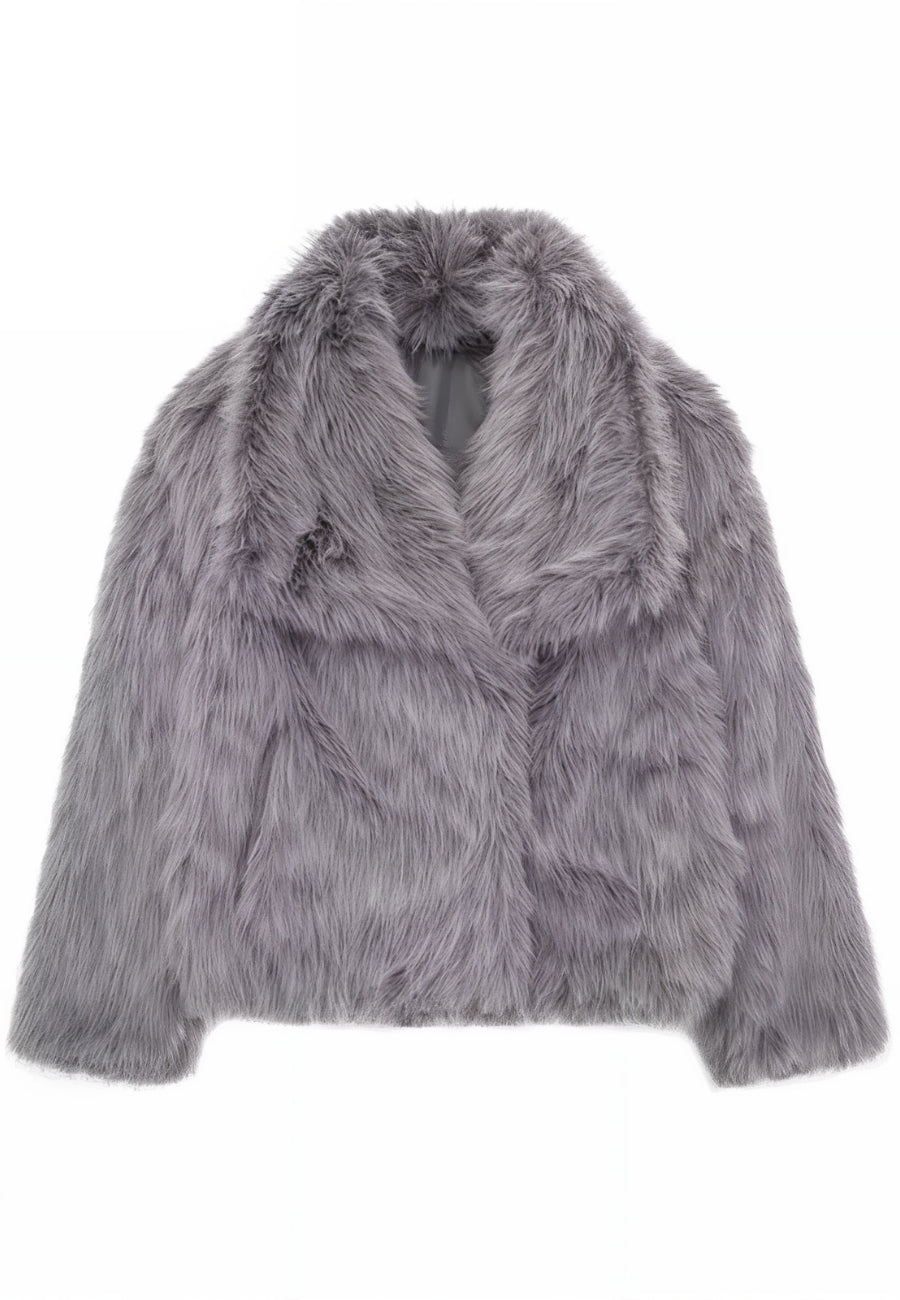 A stylish woman wearing a luxurious faux fur coat, paired with casual jeans, capturing a chic winter look perfect for elegant outings or casual wear.