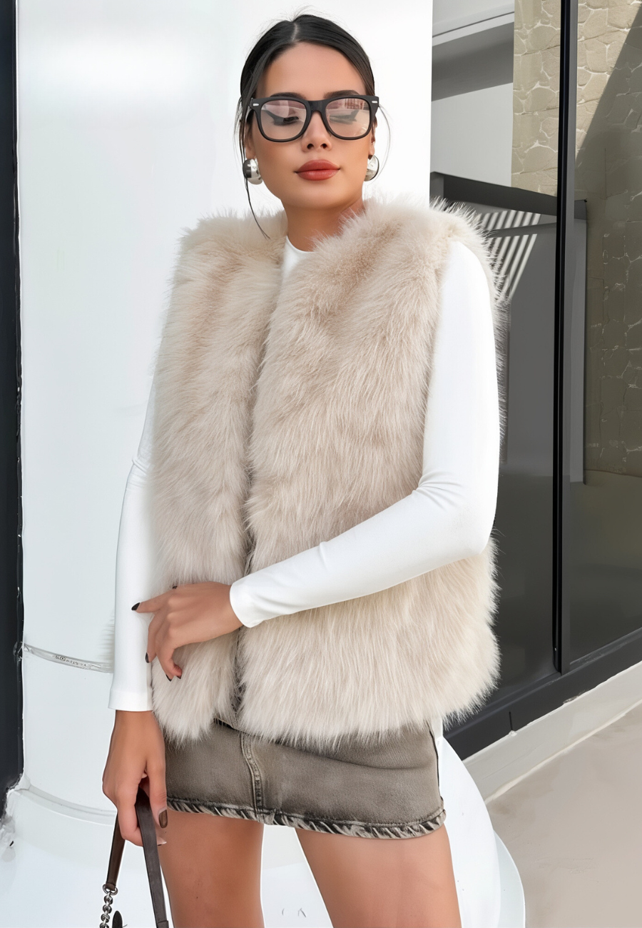 A stylish woman wearing a fluffy vest paired with a turtleneck top and a skirt, showcasing the elegant design and cozy texture of the Ava Women's Fluffy Vest, ideal for layering in chic outfits.