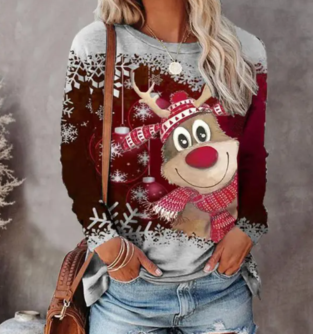 A festive women's sweater featuring a cheerful reindeer design with snowflake accents, styled casually with jeans and accessories, perfect for holiday gatherings and winter celebrations.