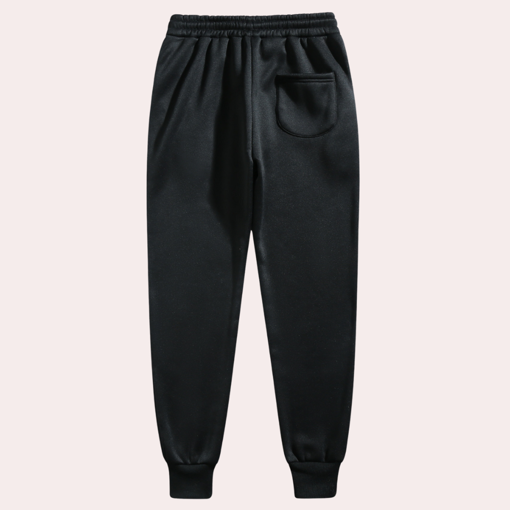 A pair of men's joggers with a relaxed fit, featuring an adjustable drawstring waistband, practical pockets, and a modern design, styled with casual sneakers.