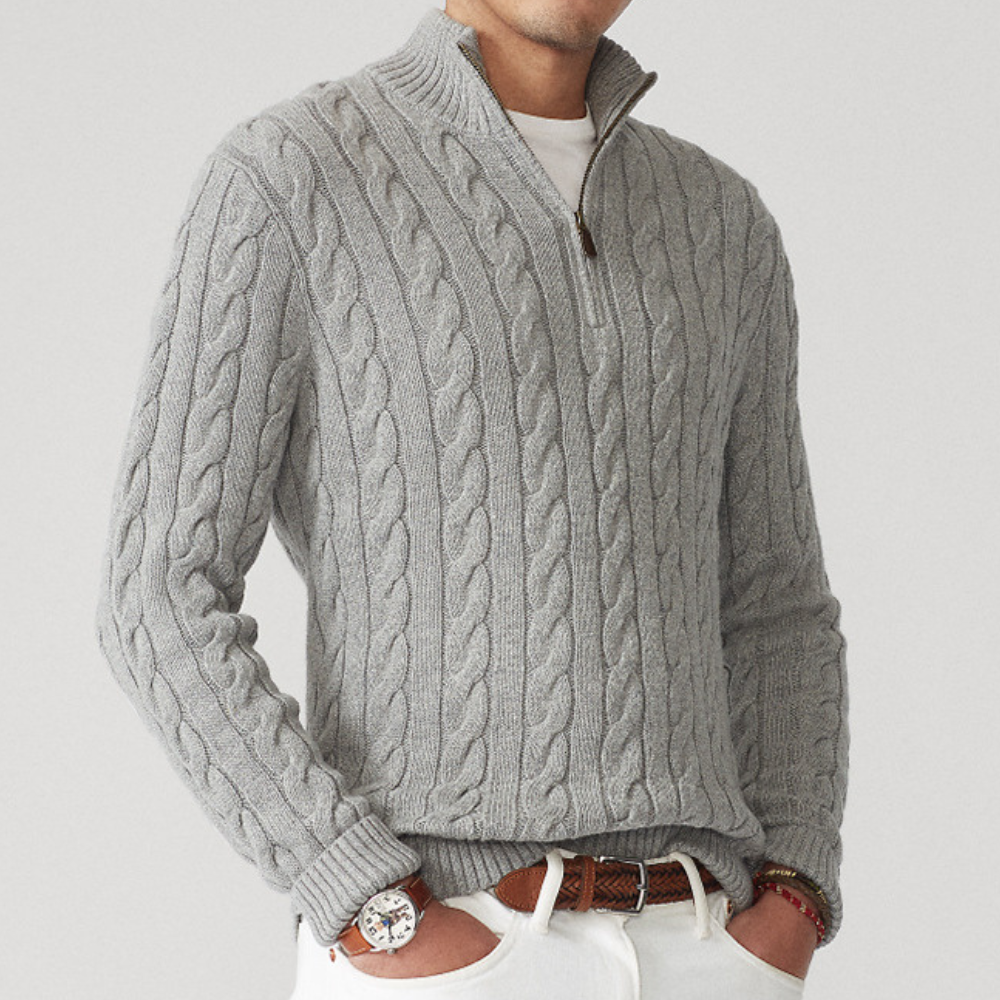 A men's cable knit sweater featuring a classic design with a zip-up collar, tailored for warmth and style, perfect for casual wear or layering in colder weather.