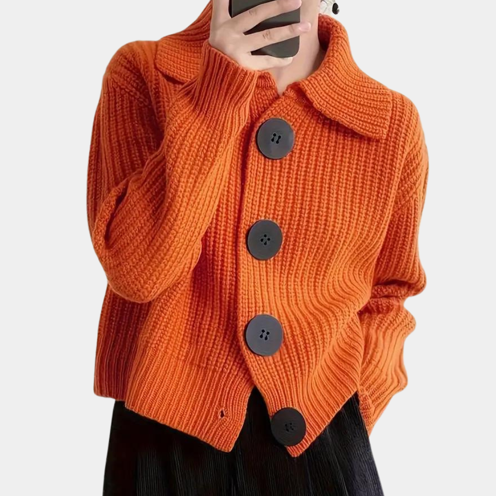 Chunky knit cardigan with oversized buttons, styled with a chic outfit for a cozy and fashionable look, perfect for layering in cooler weather.