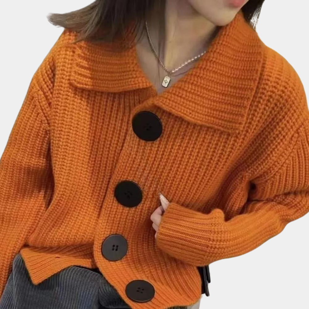 Chunky knit cardigan with oversized buttons, styled with a chic outfit for a cozy and fashionable look, perfect for layering in cooler weather.