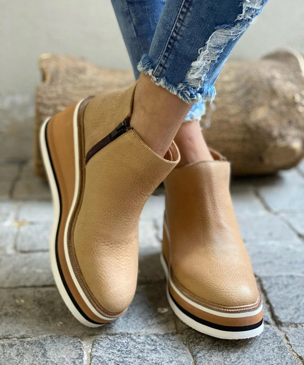 Stylish women's ankle boots with a modern design and zipper closure, displayed on a wooden floor. Perfect for casual or everyday wear.
