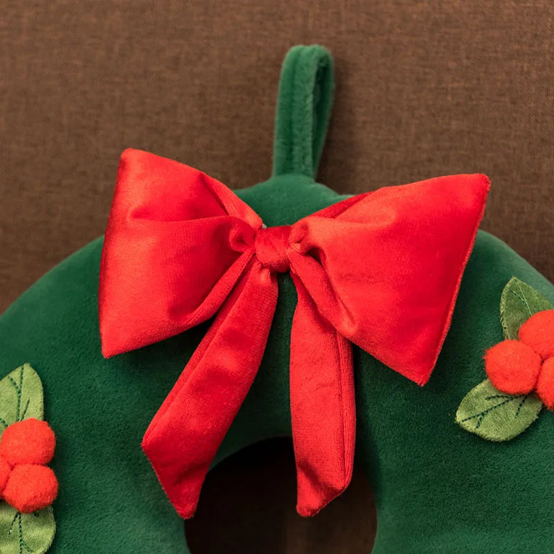 Festive plush toy set featuring a Christmas tree, gingerbread house, wreath, and gingerbread figure, displayed in a cozy holiday-themed setting with wrapped gifts and decorations.