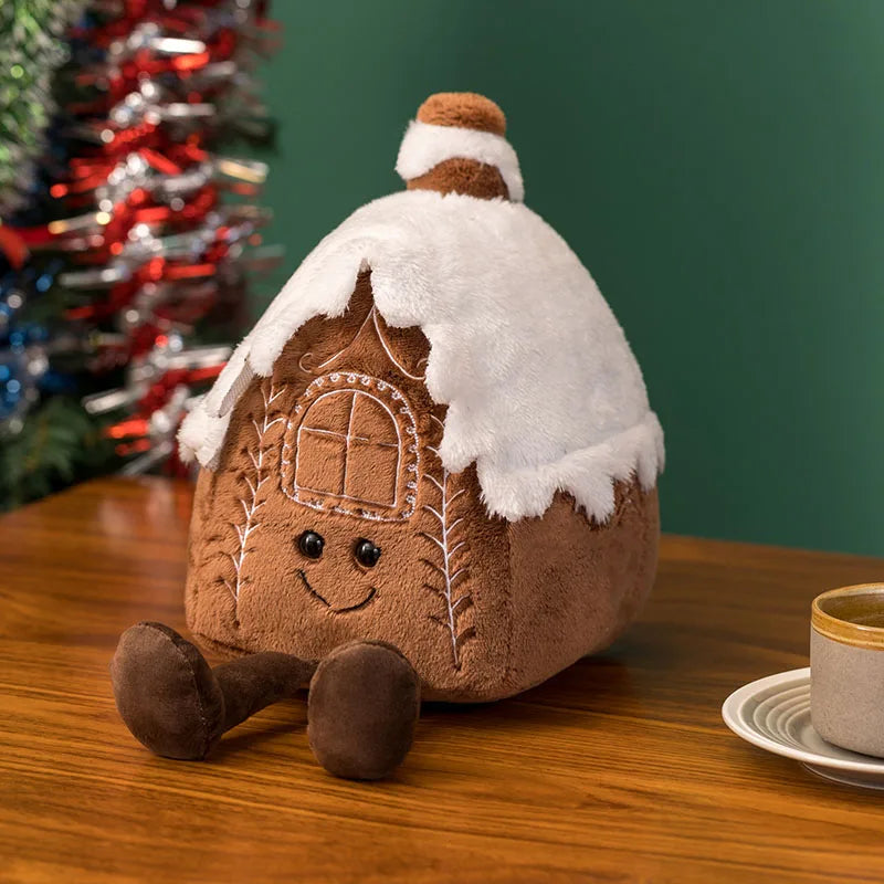 Festive plush toy set featuring a Christmas tree, gingerbread house, wreath, and gingerbread figure, displayed in a cozy holiday-themed setting with wrapped gifts and decorations.