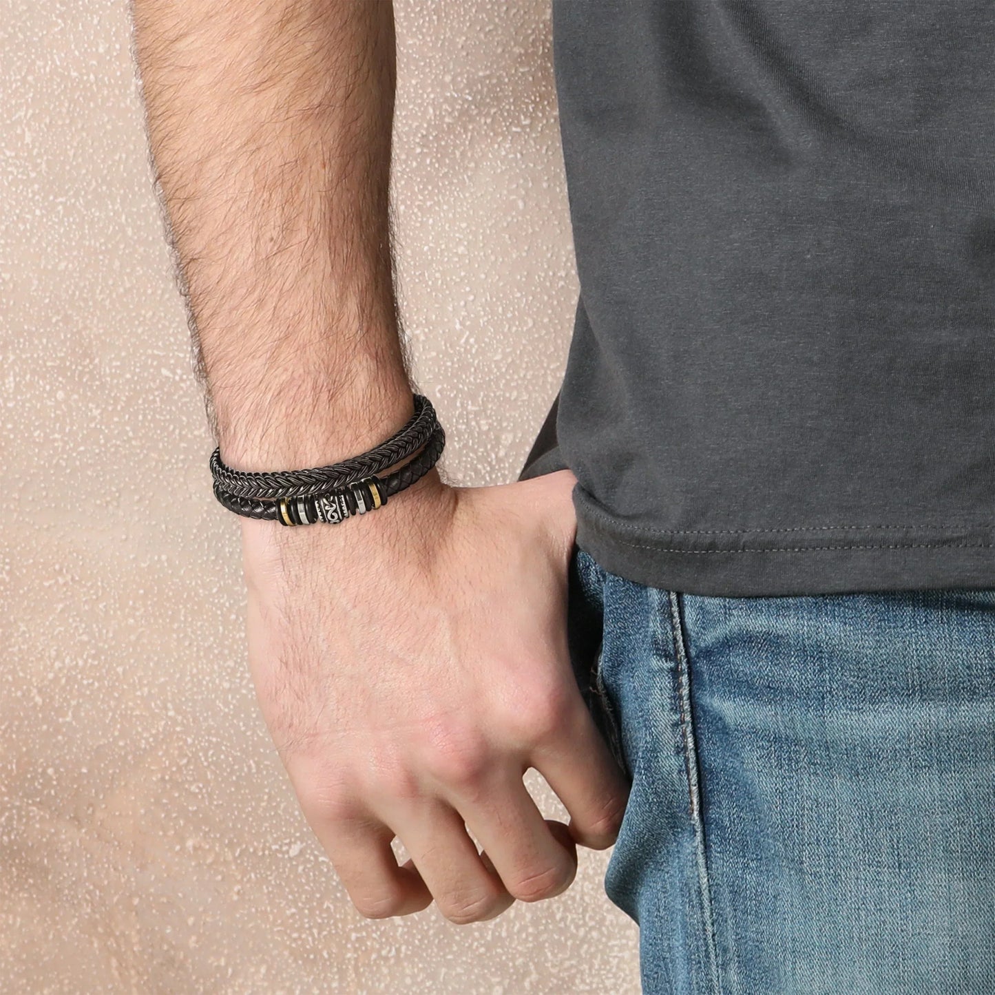 Men's multi-strand bracelet featuring a layered design with intricate details, worn on the wrist to showcase its modern and stylish appearance.