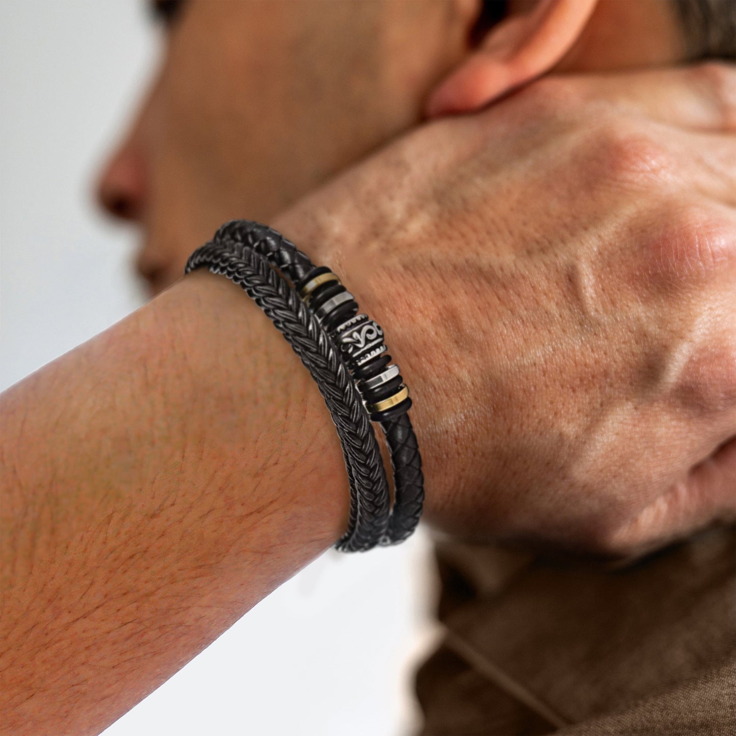 Men's multi-strand bracelet featuring a layered design with intricate details, worn on the wrist to showcase its modern and stylish appearance.