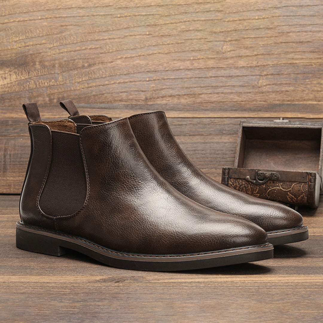 Men's ankle boots with a sleek design and durable construction, featuring a pull-tab and sturdy sole, perfect for versatile everyday wear.