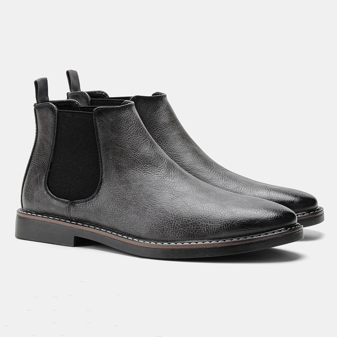 Men's ankle boots with a sleek design and durable construction, featuring a pull-tab and sturdy sole, perfect for versatile everyday wear.