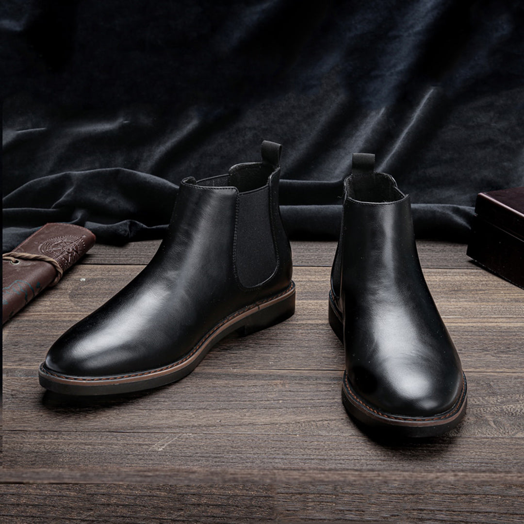 Men's ankle boots with a sleek design and durable construction, featuring a pull-tab and sturdy sole, perfect for versatile everyday wear.
