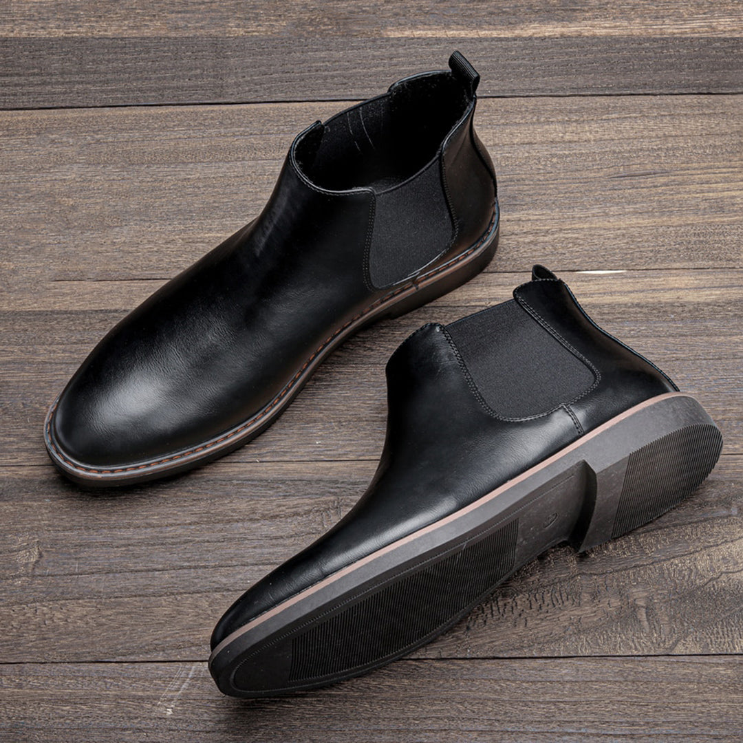 Men's ankle boots with a sleek design and durable construction, featuring a pull-tab and sturdy sole, perfect for versatile everyday wear.