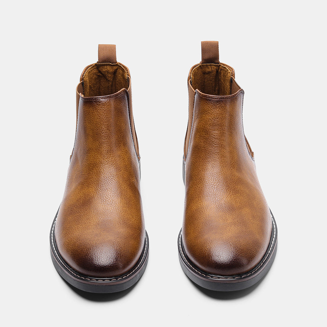 Men's ankle boots with a sleek design and durable construction, featuring a pull-tab and sturdy sole, perfect for versatile everyday wear.