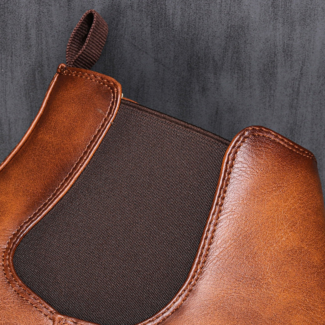 Men's ankle boots with a sleek design and durable construction, featuring a pull-tab and sturdy sole, perfect for versatile everyday wear.