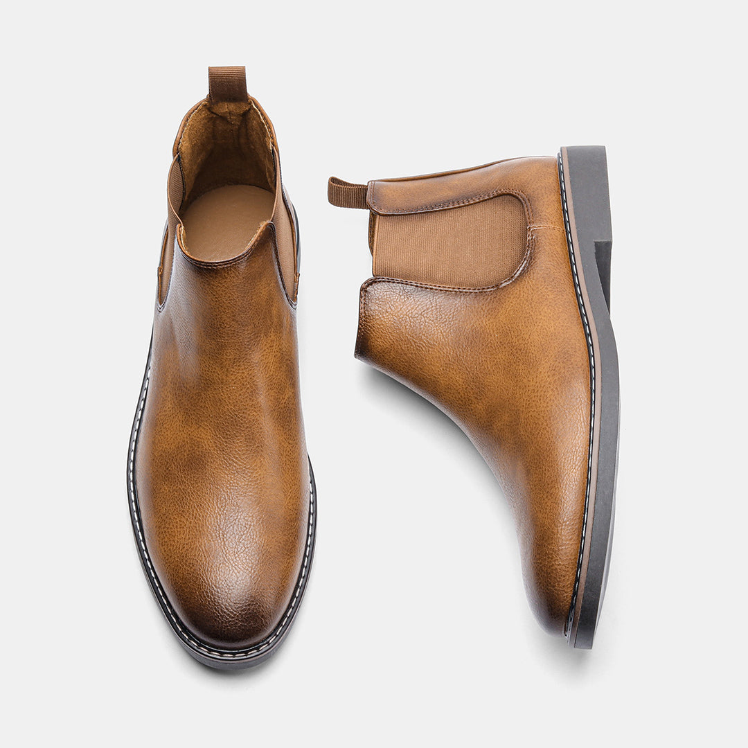 Men's ankle boots with a sleek design and durable construction, featuring a pull-tab and sturdy sole, perfect for versatile everyday wear.