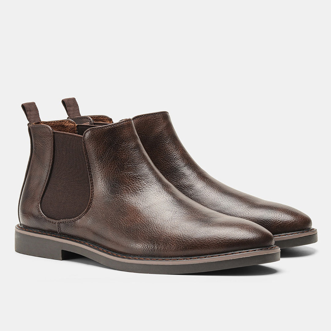 Men's ankle boots with a sleek design and durable construction, featuring a pull-tab and sturdy sole, perfect for versatile everyday wear.