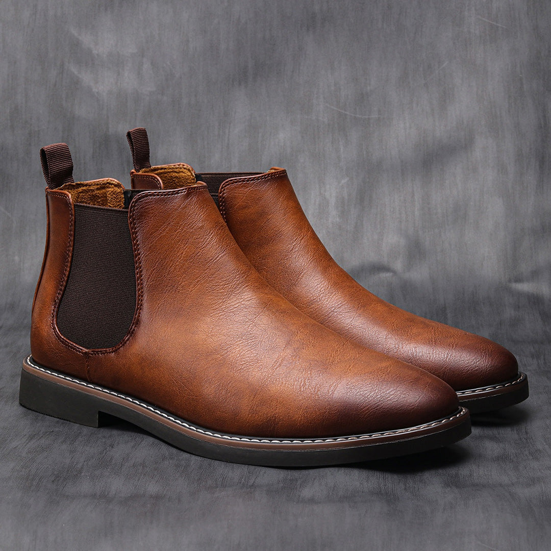Men's ankle boots with a sleek design and durable construction, featuring a pull-tab and sturdy sole, perfect for versatile everyday wear.