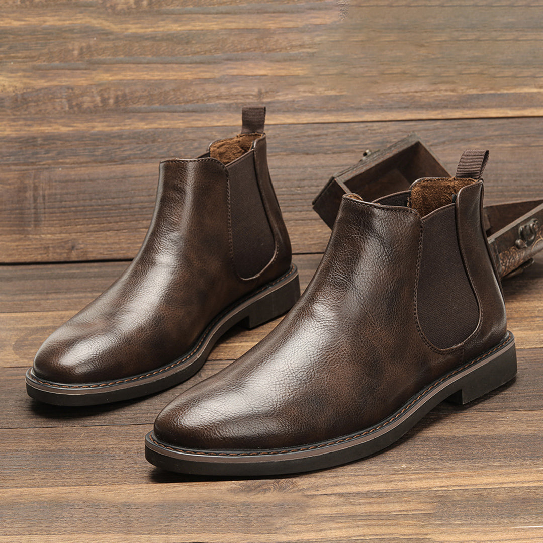 Men's ankle boots with a sleek design and durable construction, featuring a pull-tab and sturdy sole, perfect for versatile everyday wear.