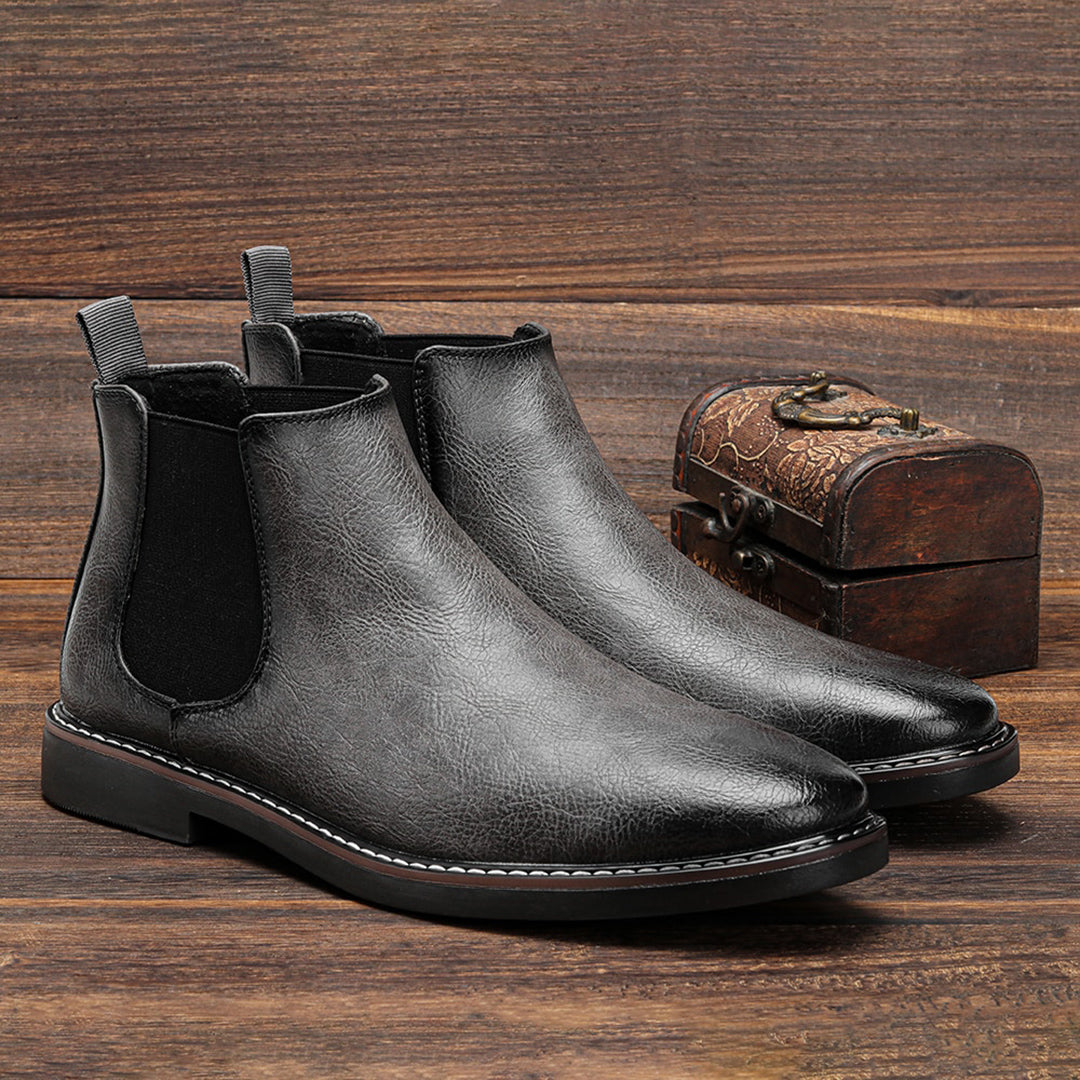 Men's ankle boots with a sleek design and durable construction, featuring a pull-tab and sturdy sole, perfect for versatile everyday wear.