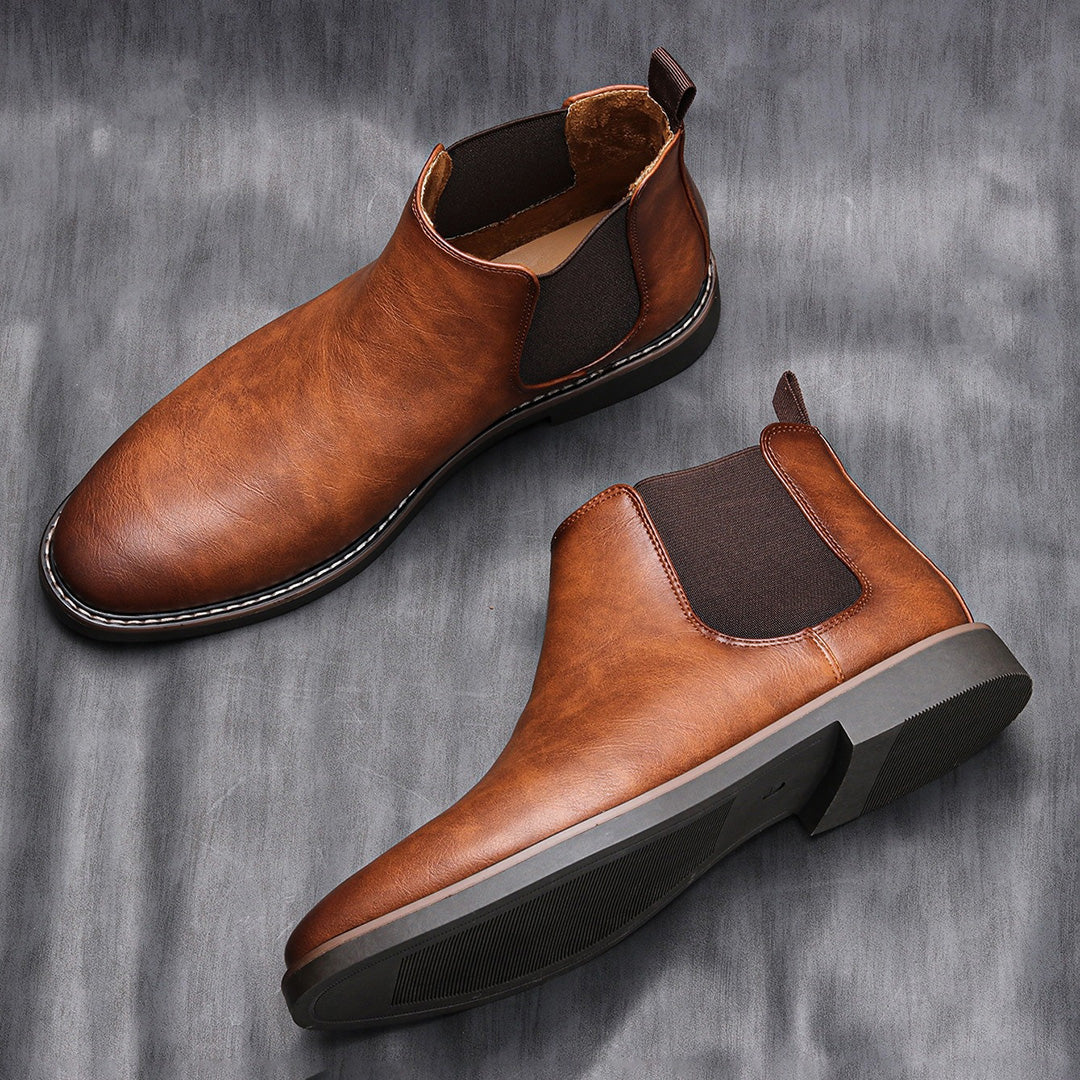 Men's ankle boots with a sleek design and durable construction, featuring a pull-tab and sturdy sole, perfect for versatile everyday wear.