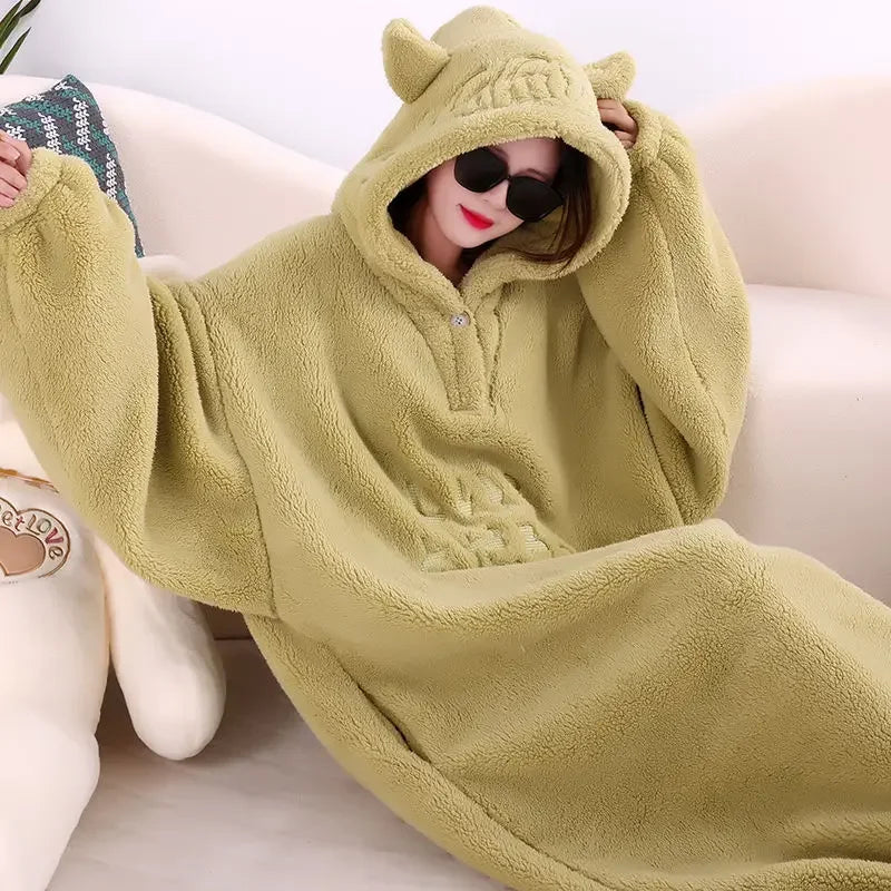 A cozy hooded blanket with an oversized design, featuring soft plush material and playful ear details on the hood, perfect for lounging at home and staying warm in style.