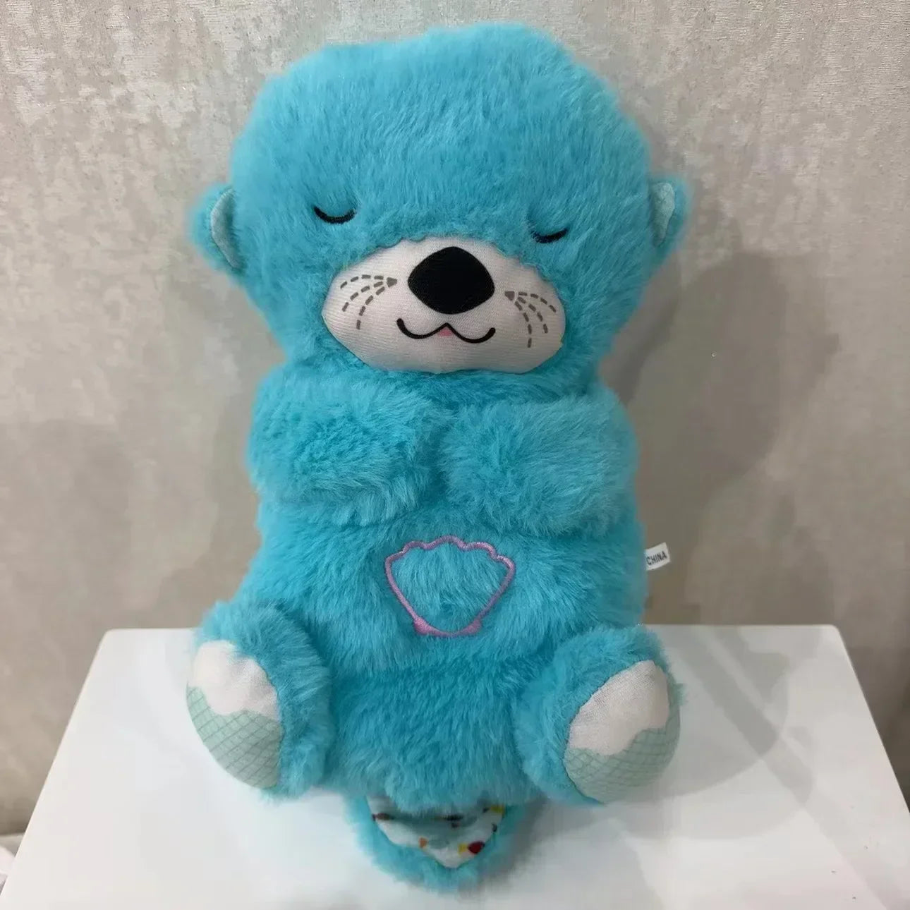 Adorable plush koala toy holding a festive pumpkin with a glowing face, designed to add charm and warmth to any holiday or celebration setting.