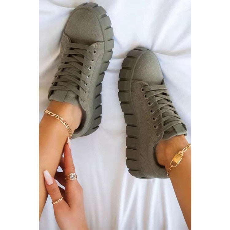 A stylish pair of women's chunky sole sneakers featuring a modern design, held in hand to showcase the bold sole and sleek details, perfect for casual or athleisure wear.