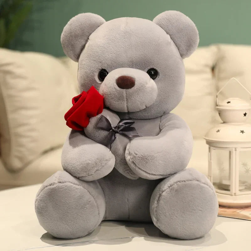 A plush toy featuring an adorable bear holding a rose and wearing a bow, designed as a perfect gift-ready item for spreading joy and love.
