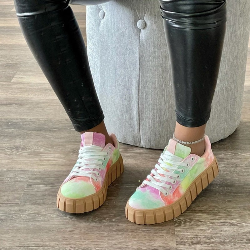 A stylish pair of women's chunky sole sneakers featuring a modern design, held in hand to showcase the bold sole and sleek details, perfect for casual or athleisure wear.