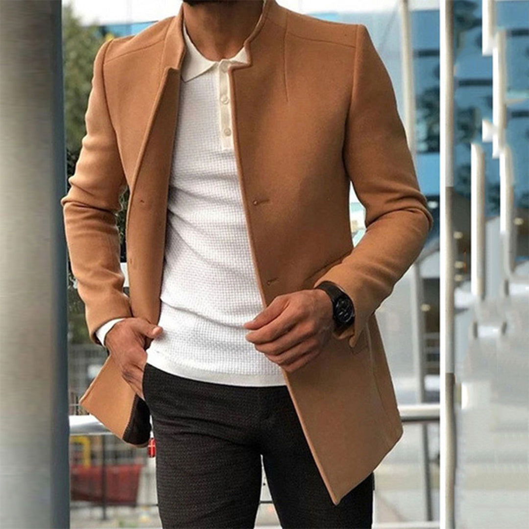 Men's tailored coat with a sleek and sophisticated design, styled over a casual shirt and trousers, perfect for formal or smart-casual occasions.