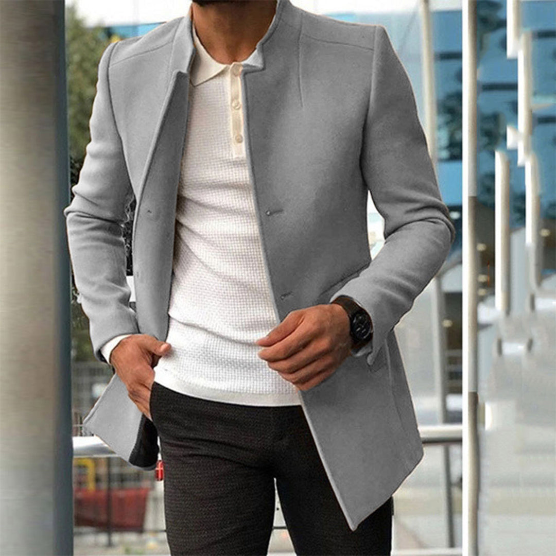 Men's tailored coat with a sleek and sophisticated design, styled over a casual shirt and trousers, perfect for formal or smart-casual occasions.