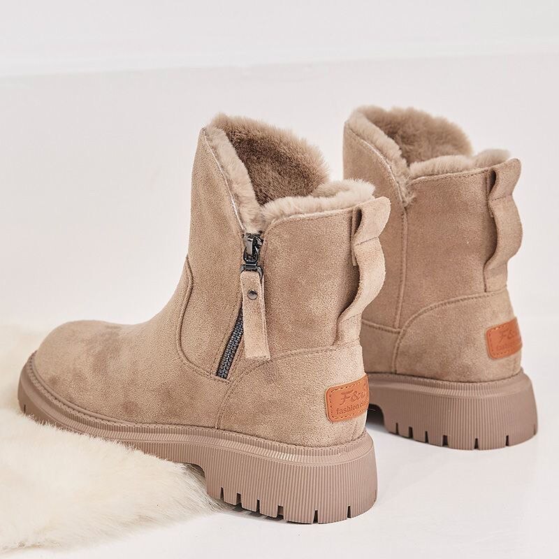 A pair of women's cozy winter boots featuring a soft lining, durable design, and a convenient side zipper for easy wear, perfect for keeping feet warm and stylish during the colder months.