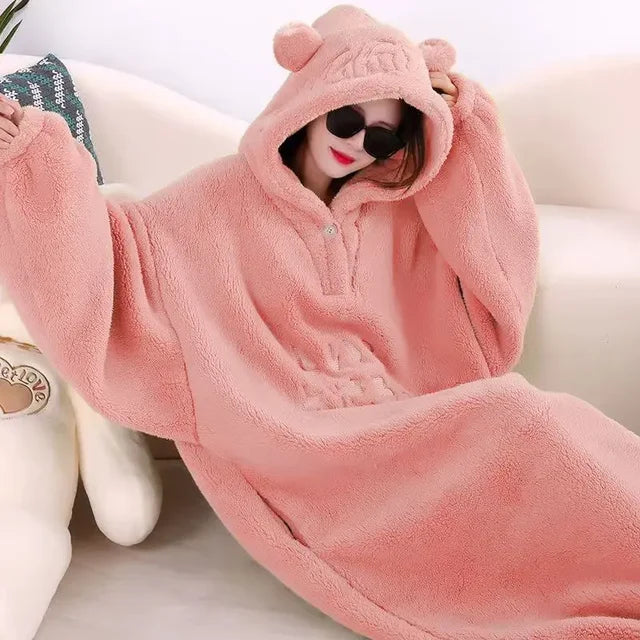 A cozy hooded blanket with an oversized design, featuring soft plush material and playful ear details on the hood, perfect for lounging at home and staying warm in style.