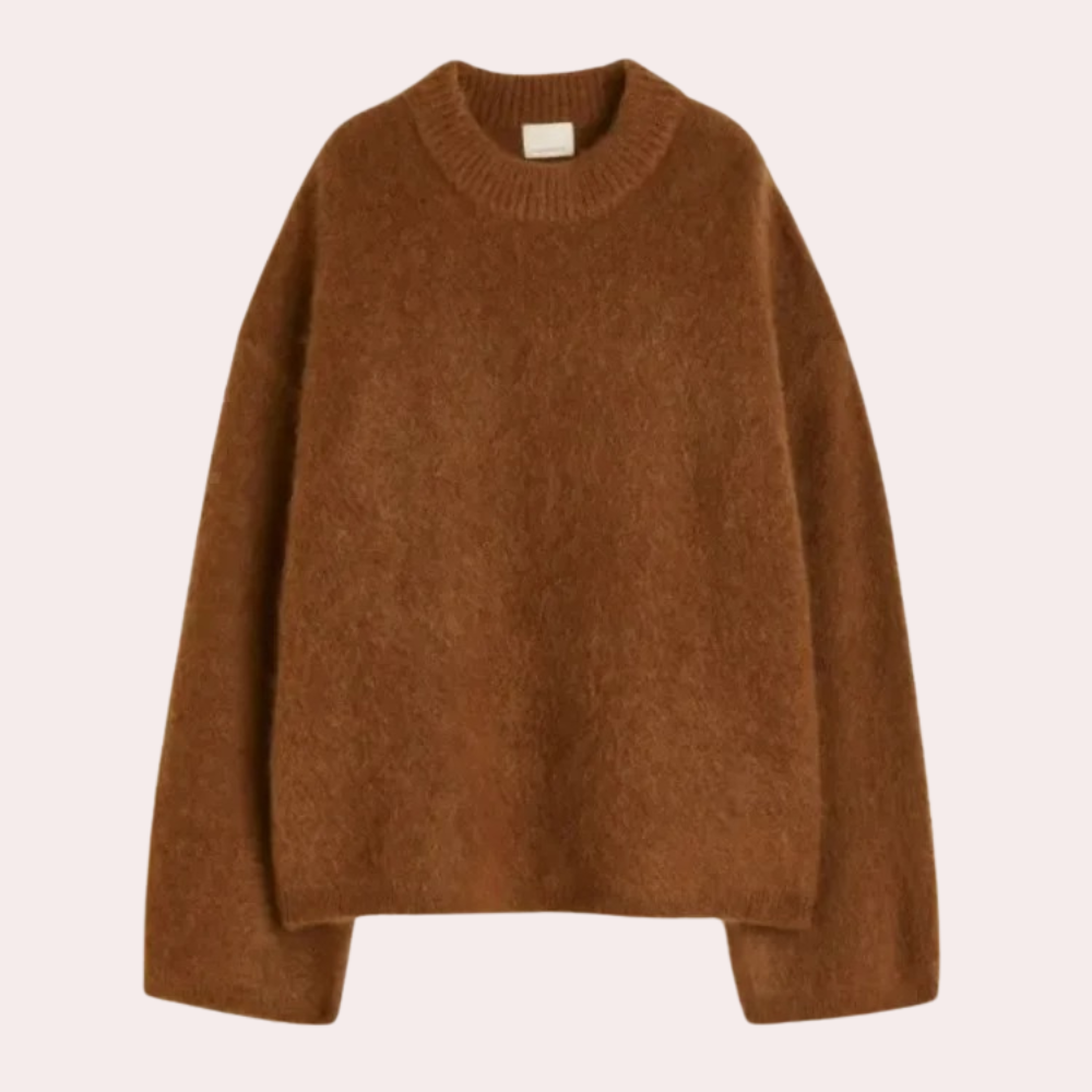 Side view of a woman wearing a relaxed fit knit sweater paired with shorts, showcasing the comfortable and cozy design of the sweater.