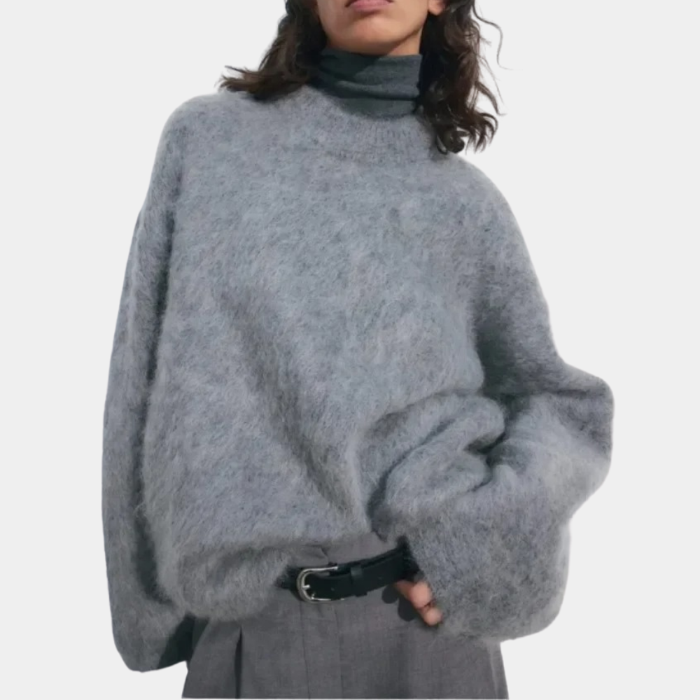 Side view of a woman wearing a relaxed fit knit sweater paired with shorts, showcasing the comfortable and cozy design of the sweater.