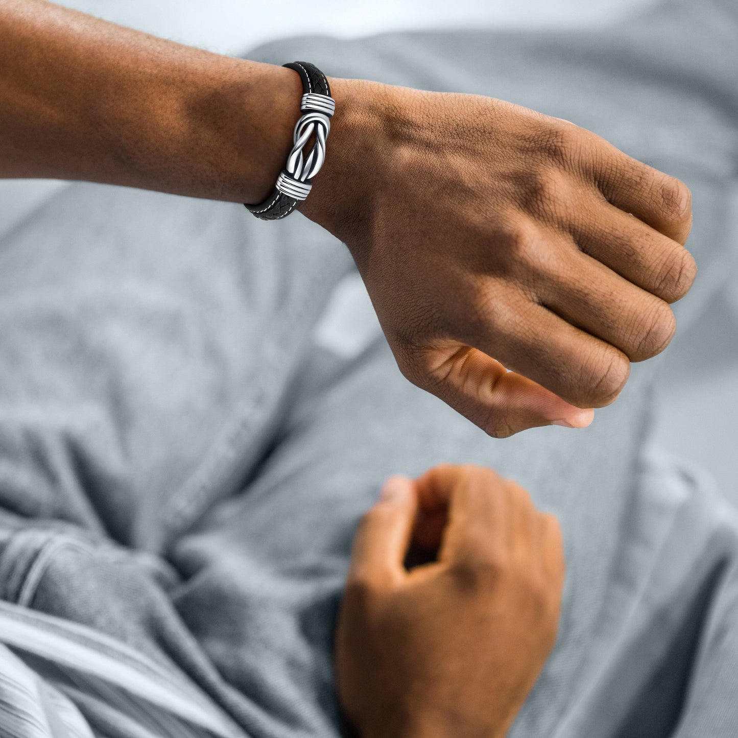 Men's braided rope bracelet with a bold and intricate design, worn on the wrist to showcase its stylish and modern appeal.