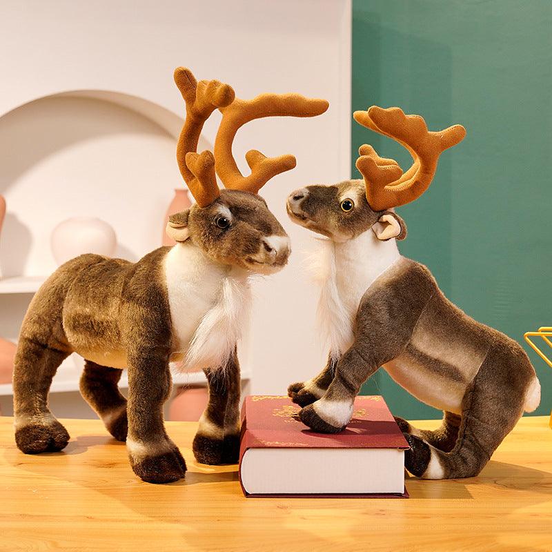 Festive plush reindeer set featuring two reindeer stacked playfully, displayed in a holiday-themed setting with decorations and gifts.