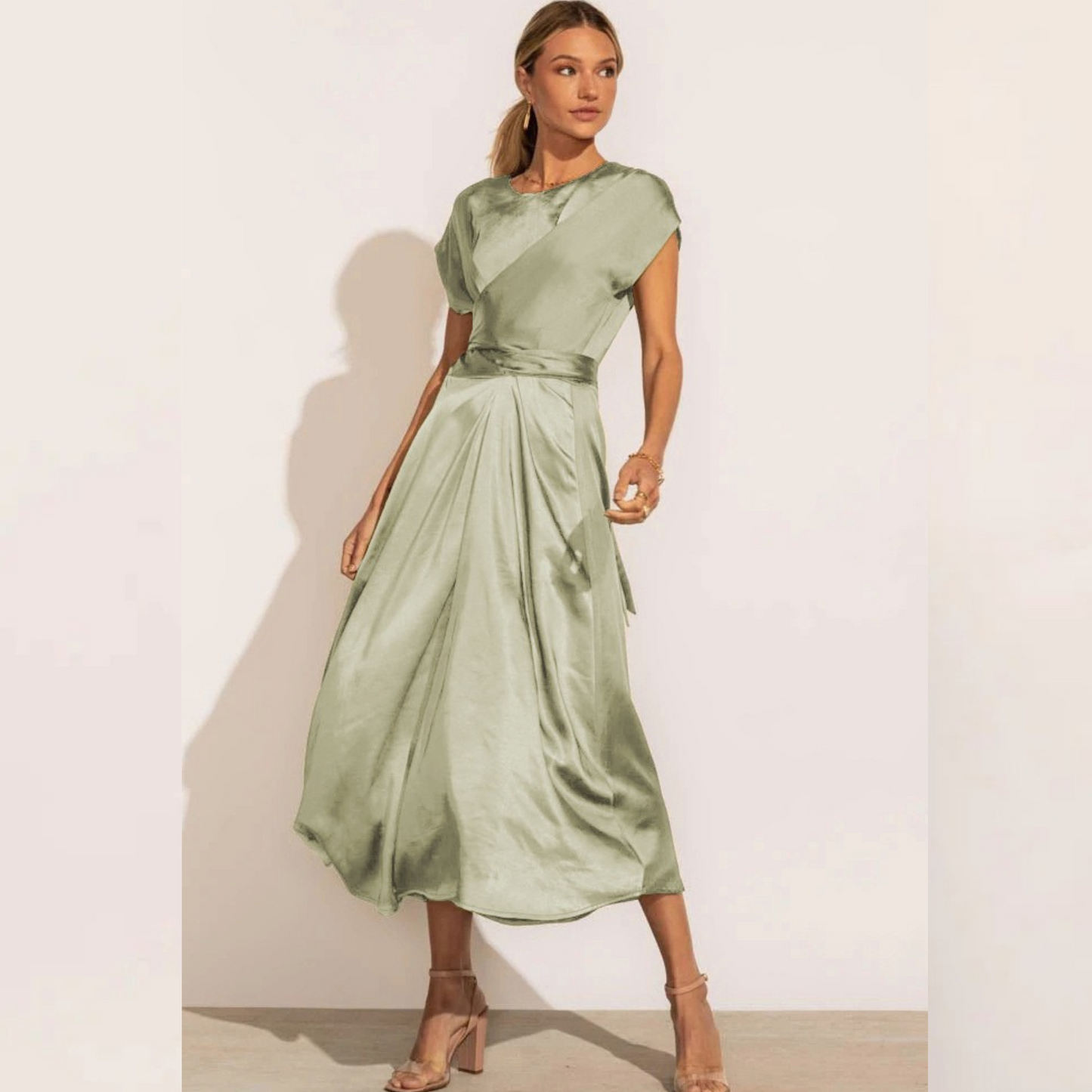 A graceful women's satin wrap dress with an elegant flow, featuring a flattering silhouette and luxurious fabric, perfect for formal occasions or special events.