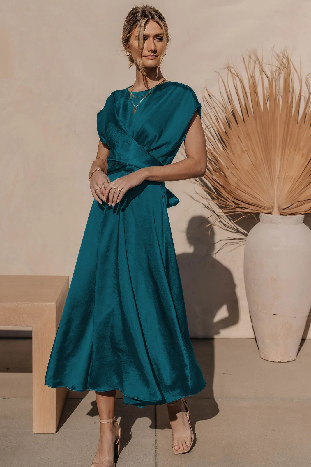 A graceful women's satin wrap dress with an elegant flow, featuring a flattering silhouette and luxurious fabric, perfect for formal occasions or special events.