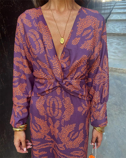 A woman wearing a floral maxi dress with an elegant fit, styled with statement accessories and heels, perfect for formal events or casual outings.