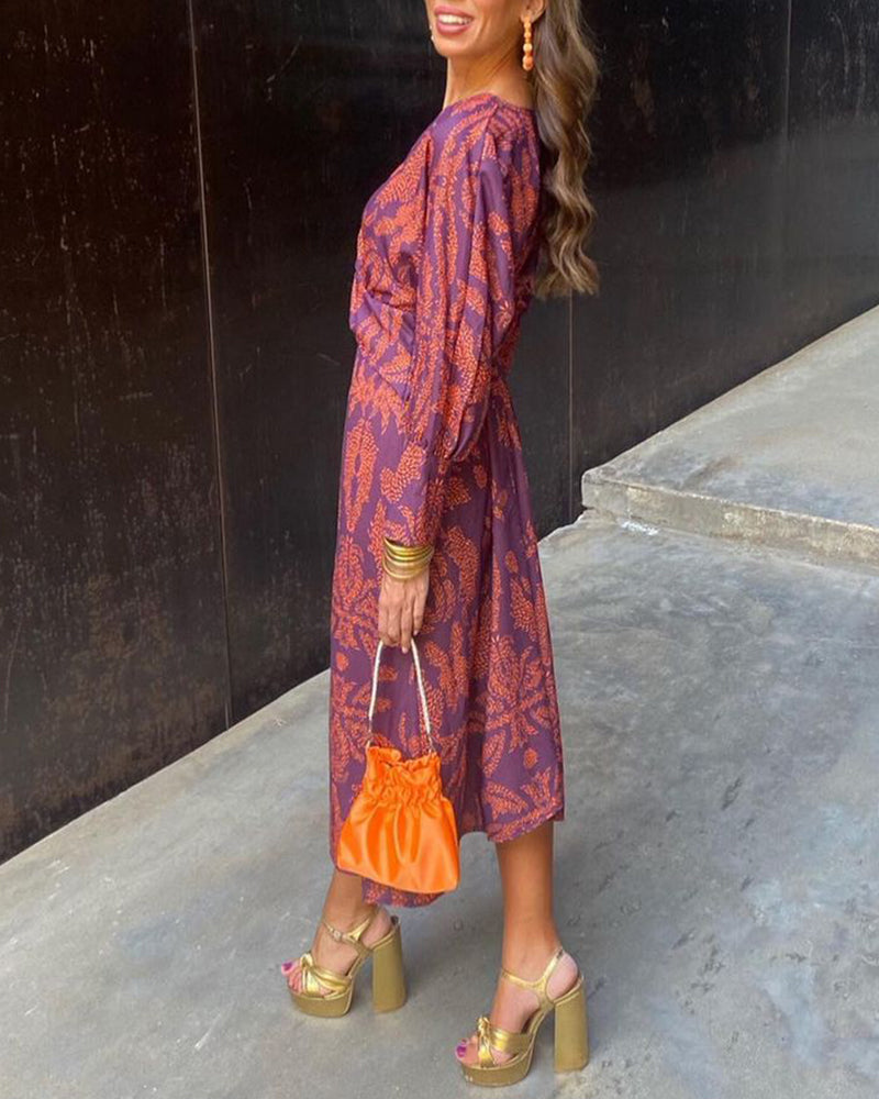 A woman wearing a floral maxi dress with an elegant fit, styled with statement accessories and heels, perfect for formal events or casual outings.