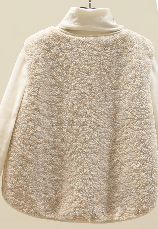 A women's sherpa vest with a cozy texture, featuring button details and functional pockets, displayed over a turtleneck sweater for a stylish layered look.