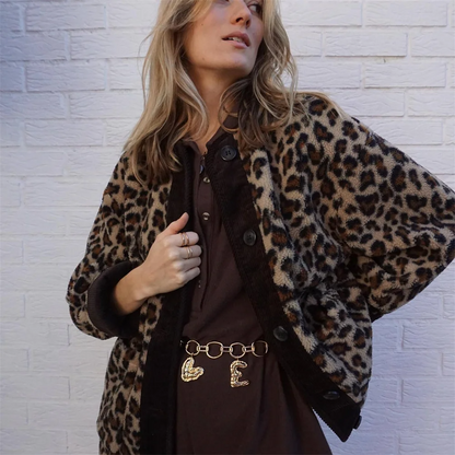 A women's patterned jacket with a bold statement design, styled with a chic outfit, perfect for adding a touch of confidence and unique flair to casual or semi-formal looks.