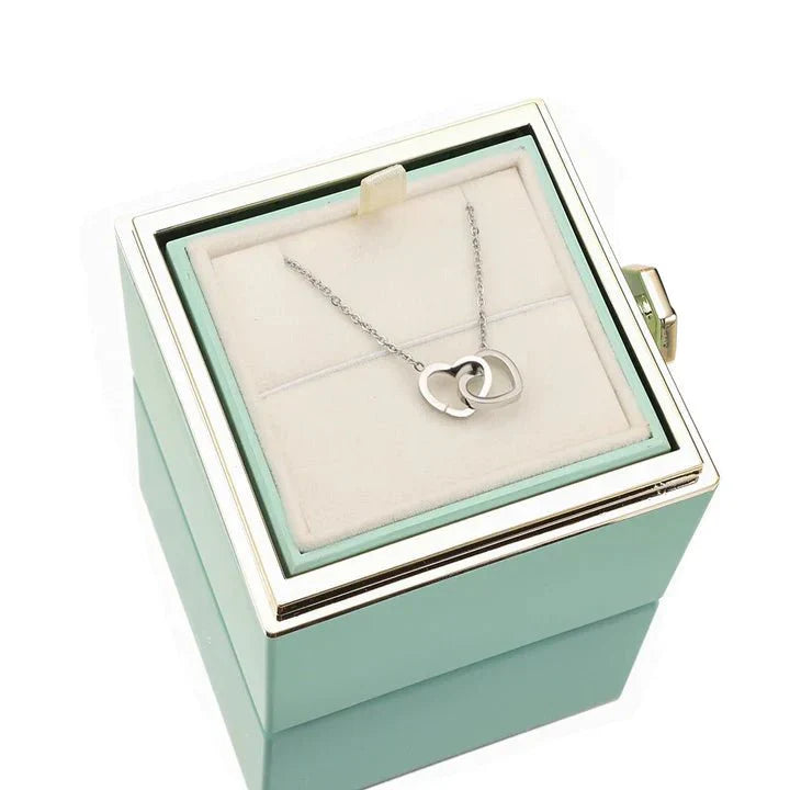 Elegant interlocking necklace displayed in a luxurious jewelry box, highlighting its timeless and sophisticated design.