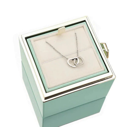 Elegant interlocking necklace displayed in a luxurious jewelry box, highlighting its timeless and sophisticated design.