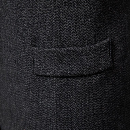 Man wearing a tailored vest paired with a shirt and jeans, holding a camera, showcasing a classic and versatile outfit.
