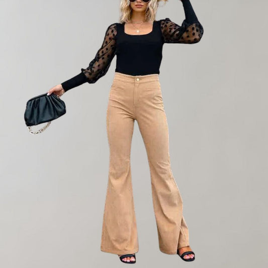 Women's high-waist flared pants paired with a cropped top, styled with a handbag and sandals, perfect for a chic and trendy look.