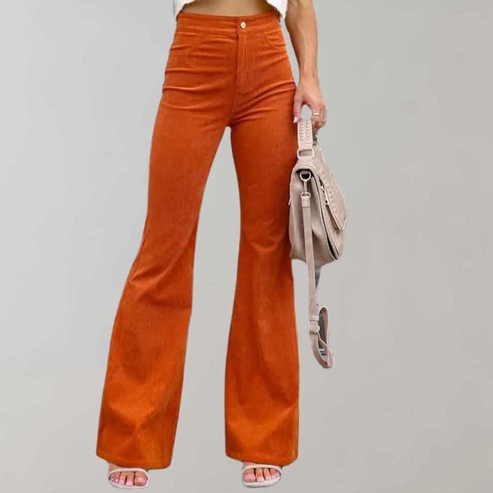 Women's high-waist flared pants paired with a cropped top, styled with a handbag and sandals, perfect for a chic and trendy look.